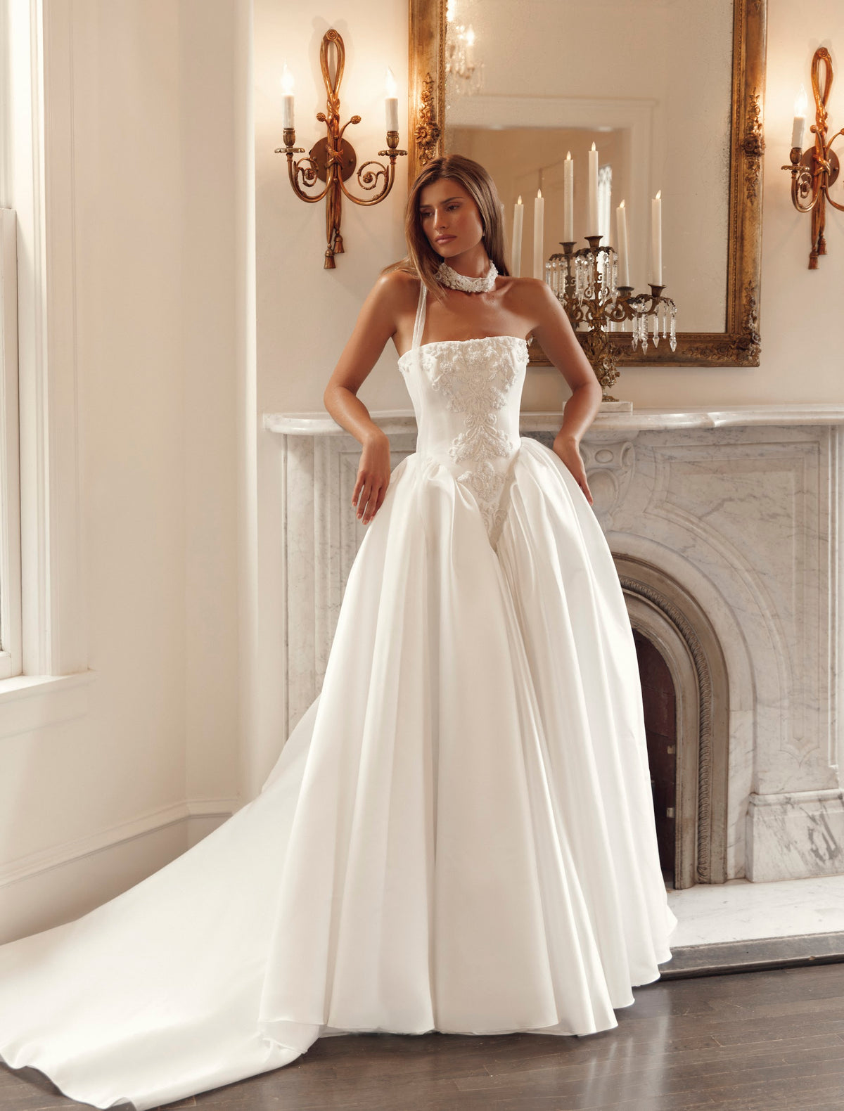 Julie Vino Genevive 3202 strapless ball gown wedding dress with a straight neckline, pointed lace corset bodice and full skirt.