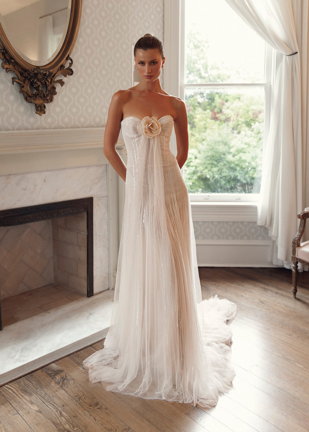 Front view of Julie Vino Antonia 3205 strapless wedding dress with a sweetheart neckline, sculptural flower and vertical beadwork.
