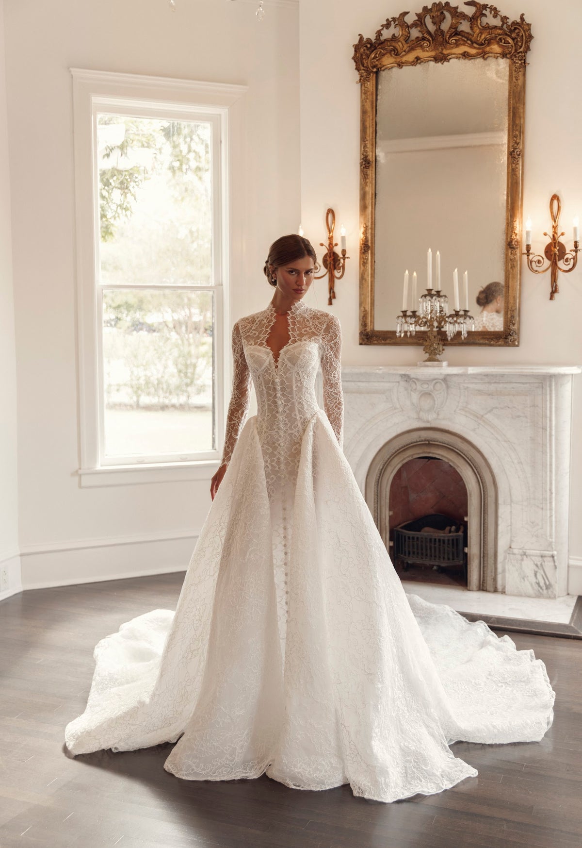 Front view of Julie Vino Collette 3207 lace ball gown wedding dress with long illusion sleeves, a high collar and a sculpted corset bodice.