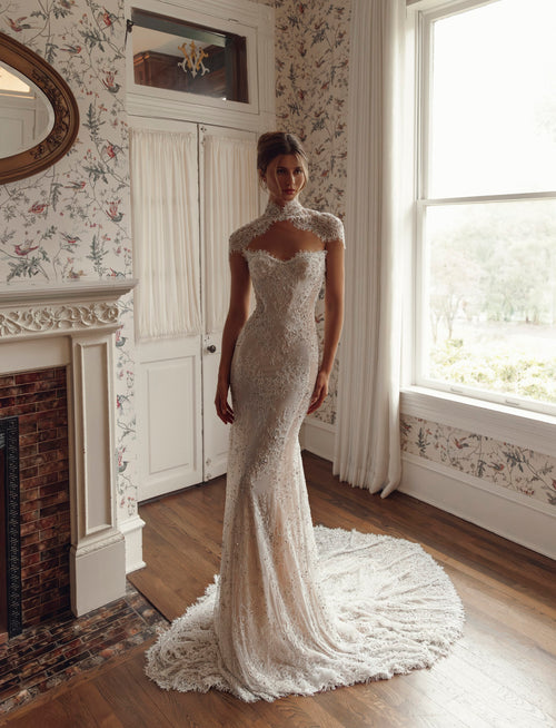Front view of Julie Vino Noelle 3209 fitted lace wedding dress with a sweetheart neckline, styled with a high-neck lace capelet.