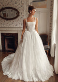 Front view of Mimosa by Julie Vino Brigette MB27-22 lace ball gown with a square neckline, pointed corset waist and full skirt.