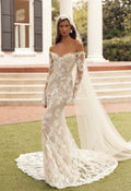 Front view of Mimosa by Julie Vino Petra MB27-23 fitted floral lace wedding dress with an off-shoulder sweetheart neckline and long illusion sleeves.