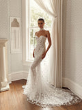 Front view of Mimosa by Julie Vino Louisa MB27-28 strapless mermaid wedding dress with a sweetheart neckline, raised floral appliqués and sweeping train.