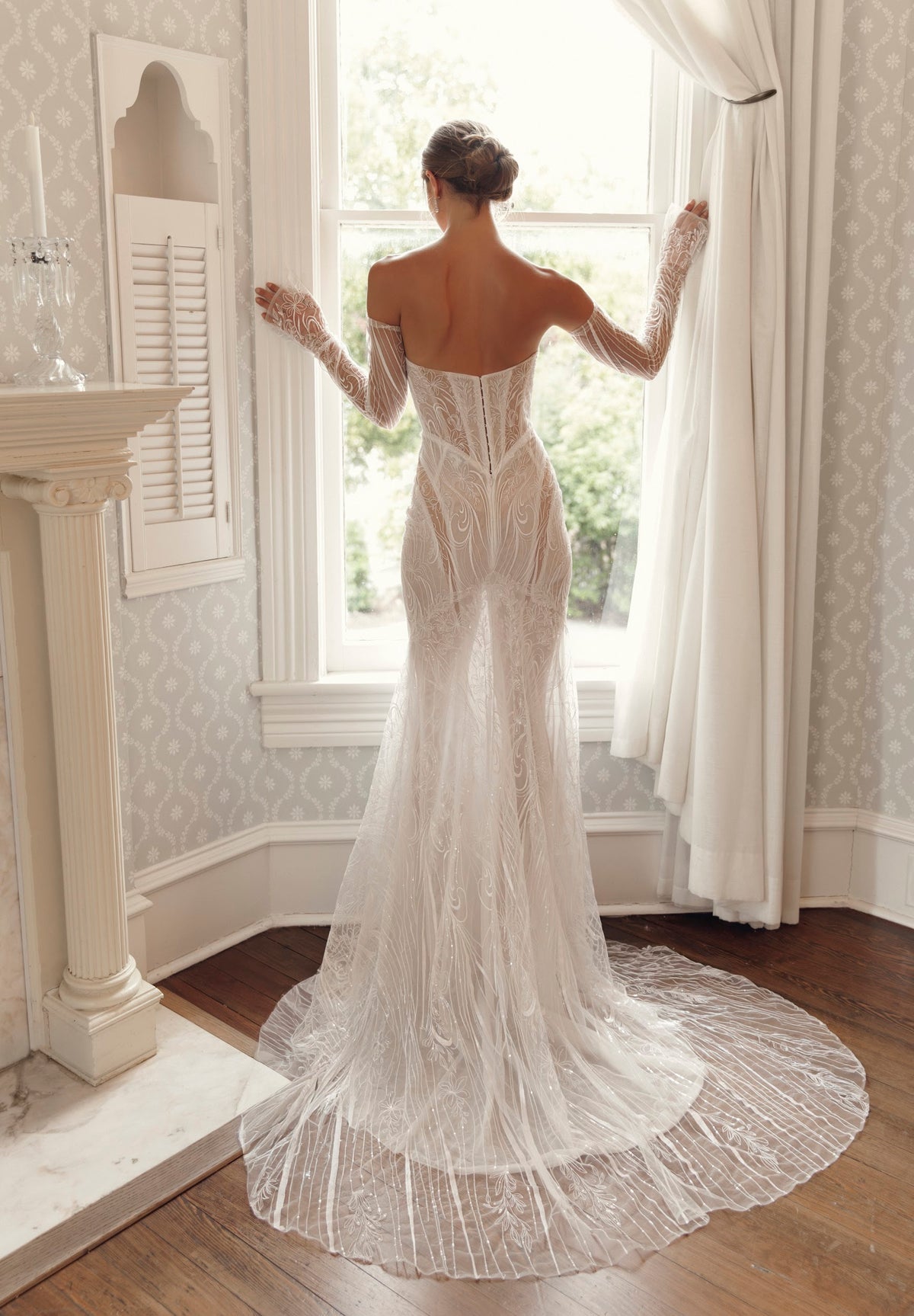 Back view of Giselle MB27-30 by Mimosa by Julie Vino, showing the low back, fitted lace silhouette and sweeping patterned lace train.