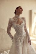 Woman wearing a white lace wedding dress in a softly lit room.