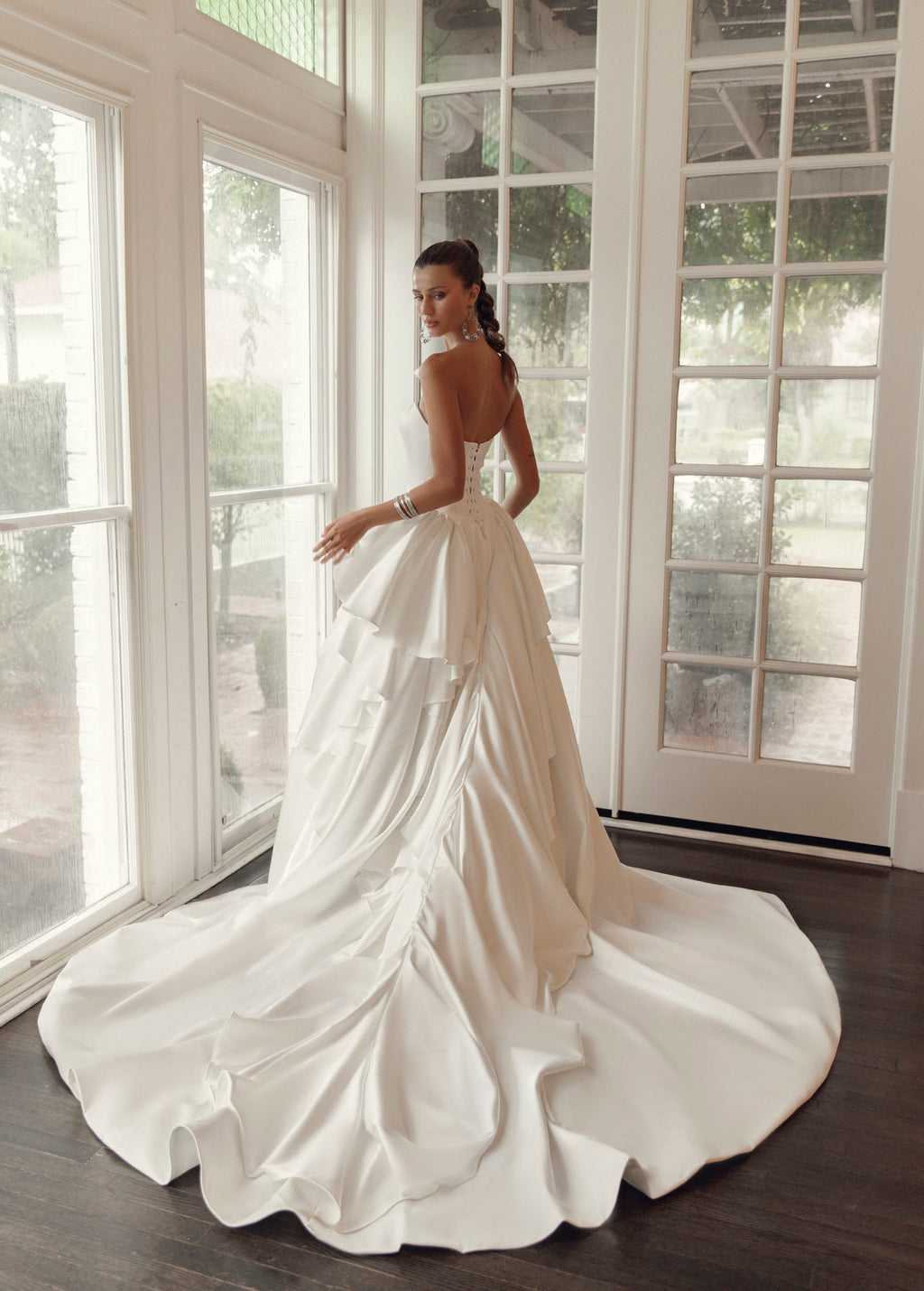Back view of Valentina PR27-21 by Pure by Julie Vino, showing the lace-up corset bodice, layered ruffles and long sweeping train.