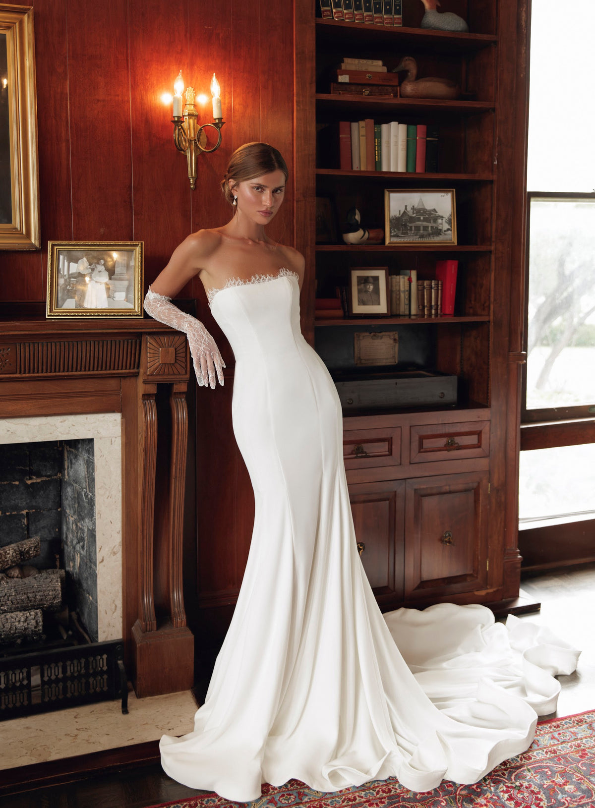 Front view of Simone PR27-24 by Pure by Julie Vino, showing the lace-trimmed strapless neckline, fitted silhouette and flared skirt, styled with lace gloves.