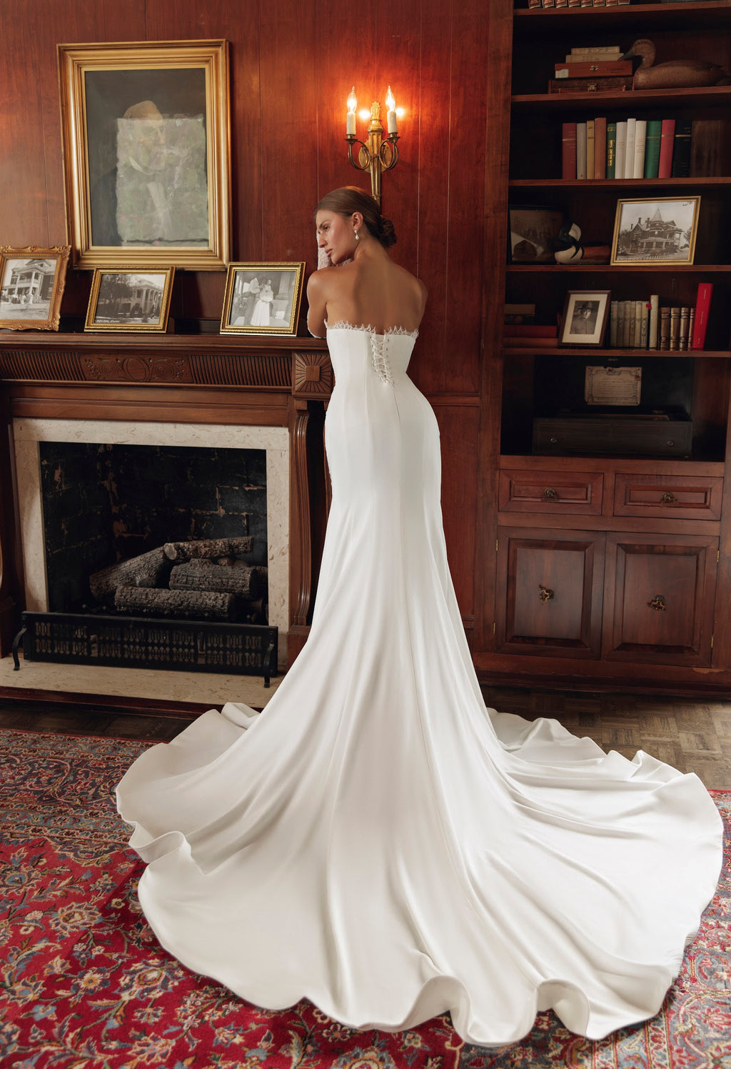Back view of Simone PR27-24 by Pure by Julie Vino, showing the lace-edged neckline, corset lacing and long sweeping train.