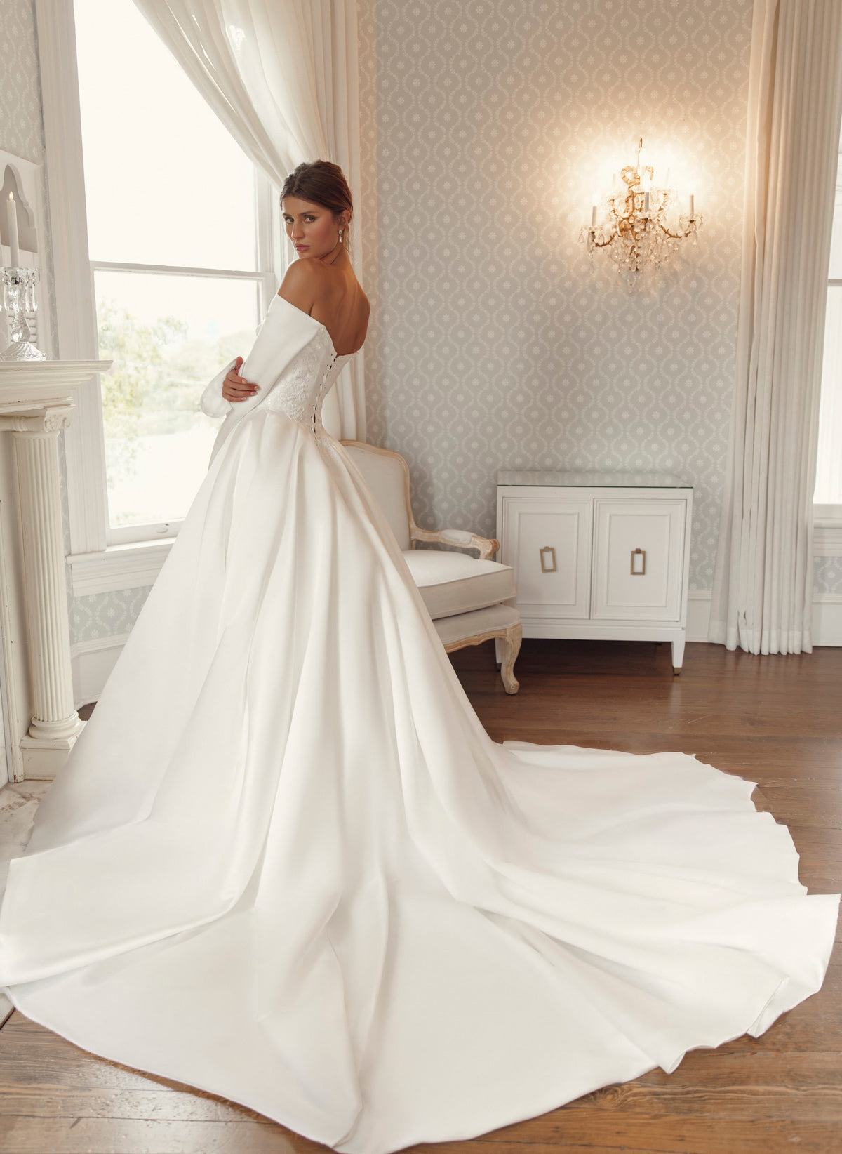 Front view of Lisette PR27-26 by Pure by Julie Vino, showing the off-the-shoulder neckline, long sleeves, lace bodice accents and full ball gown skirt.