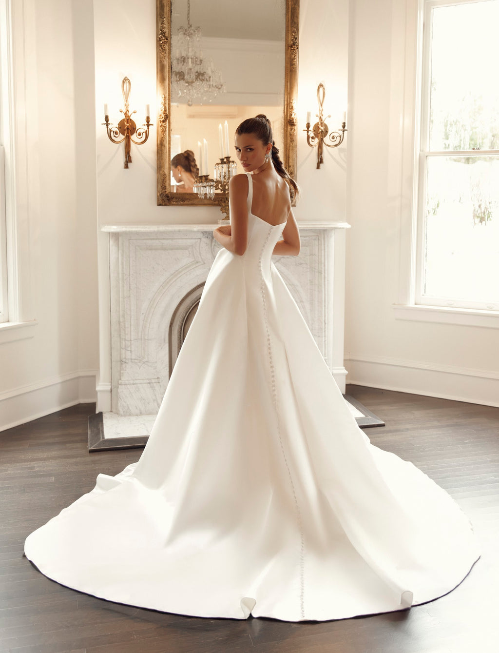 Back view of Jessica PR32-33 by Pure by Julie Vino, showing the low neckline and covered buttons extending down the full skirt and sweeping train.
