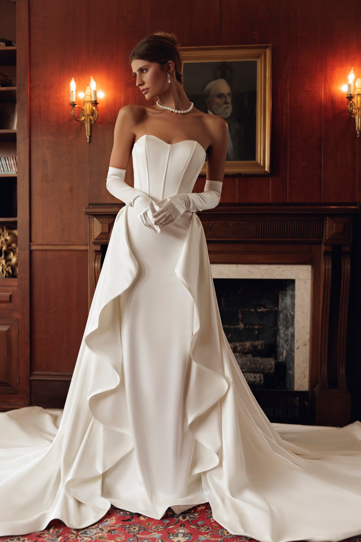 Front view of Romy PR27-31 by Pure by Julie Vino, showing the strapless corset bodice, styled with an open-front ruffled overskirt and long gloves.